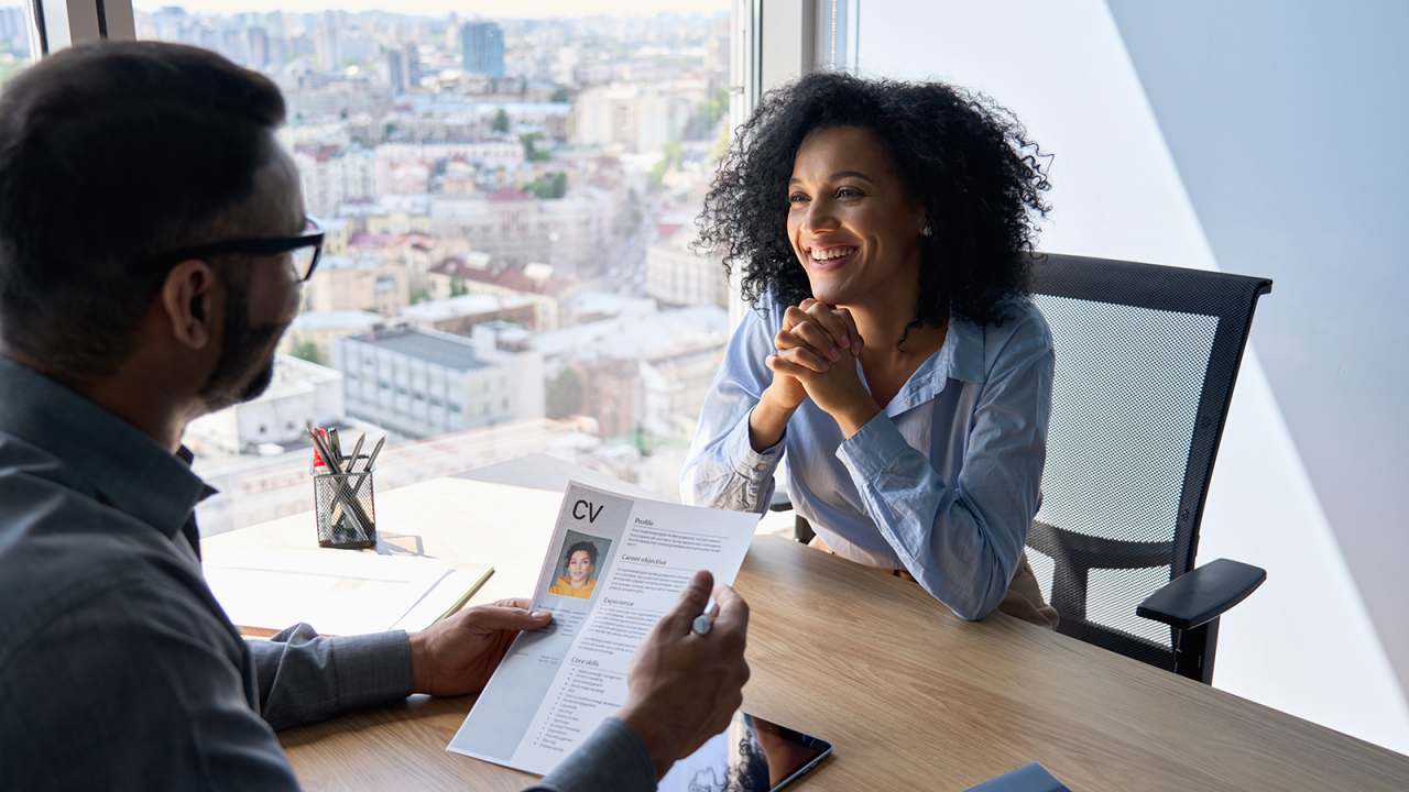Friendly interview between Indian HR manager and African American applicant.